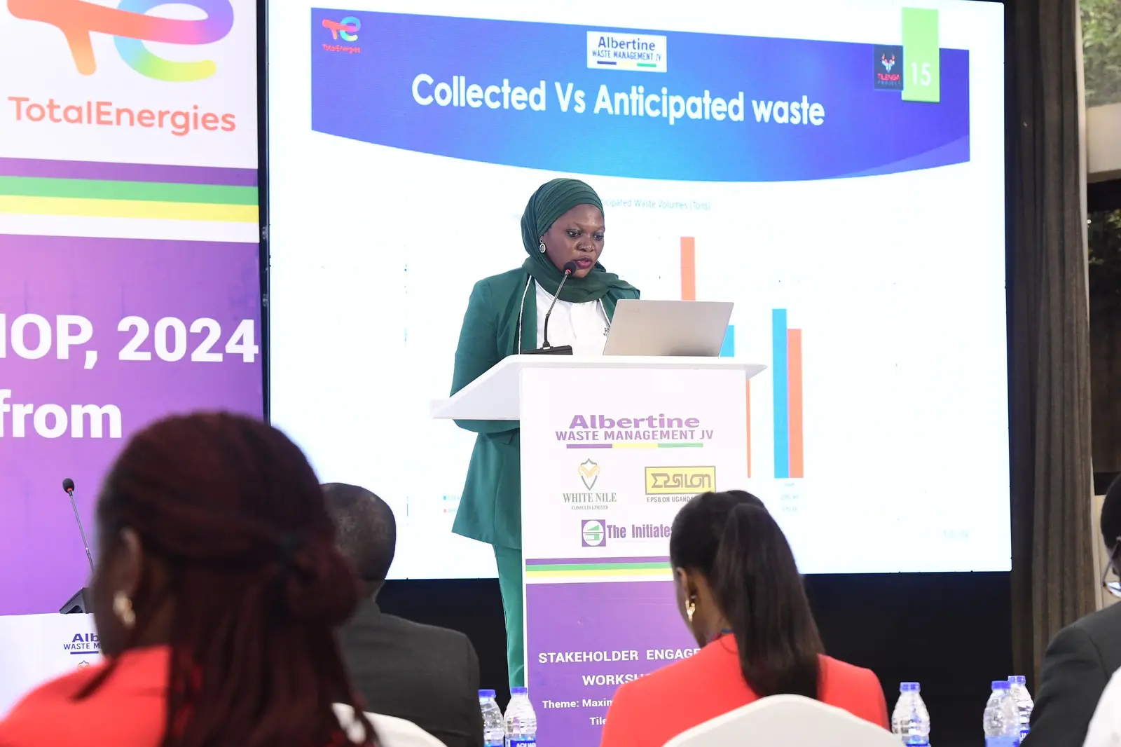 Presenter showing a chart of collected versus anticipated waste