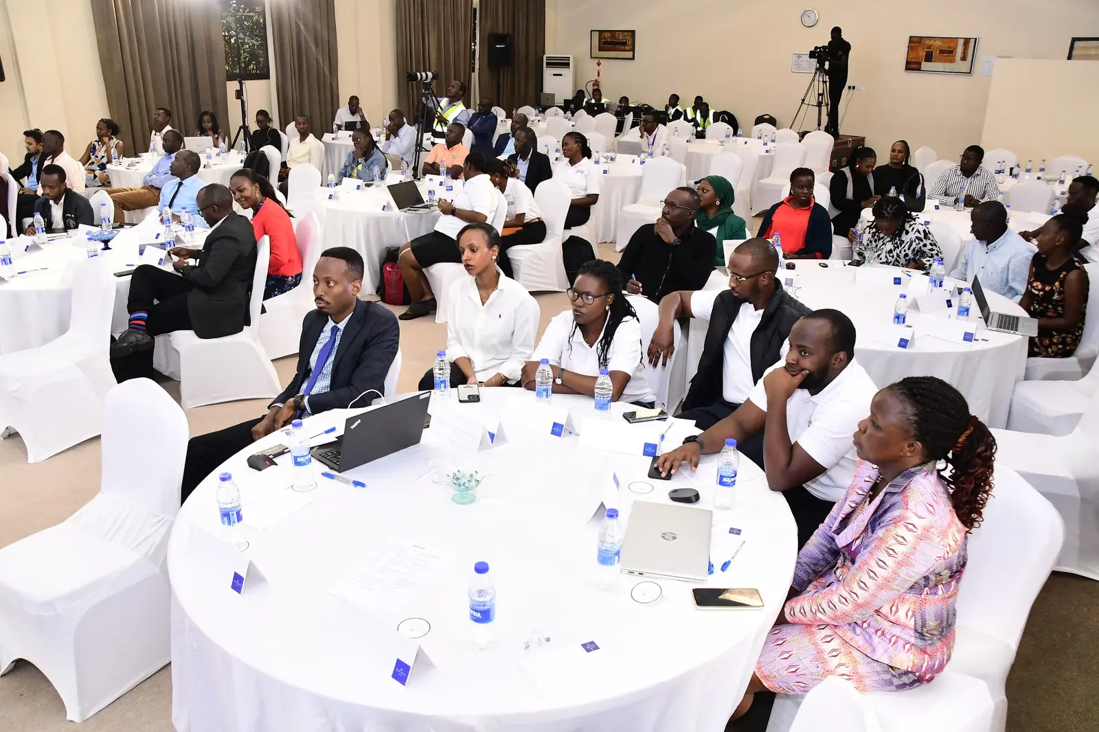 Participants seated at round tables during the workshop