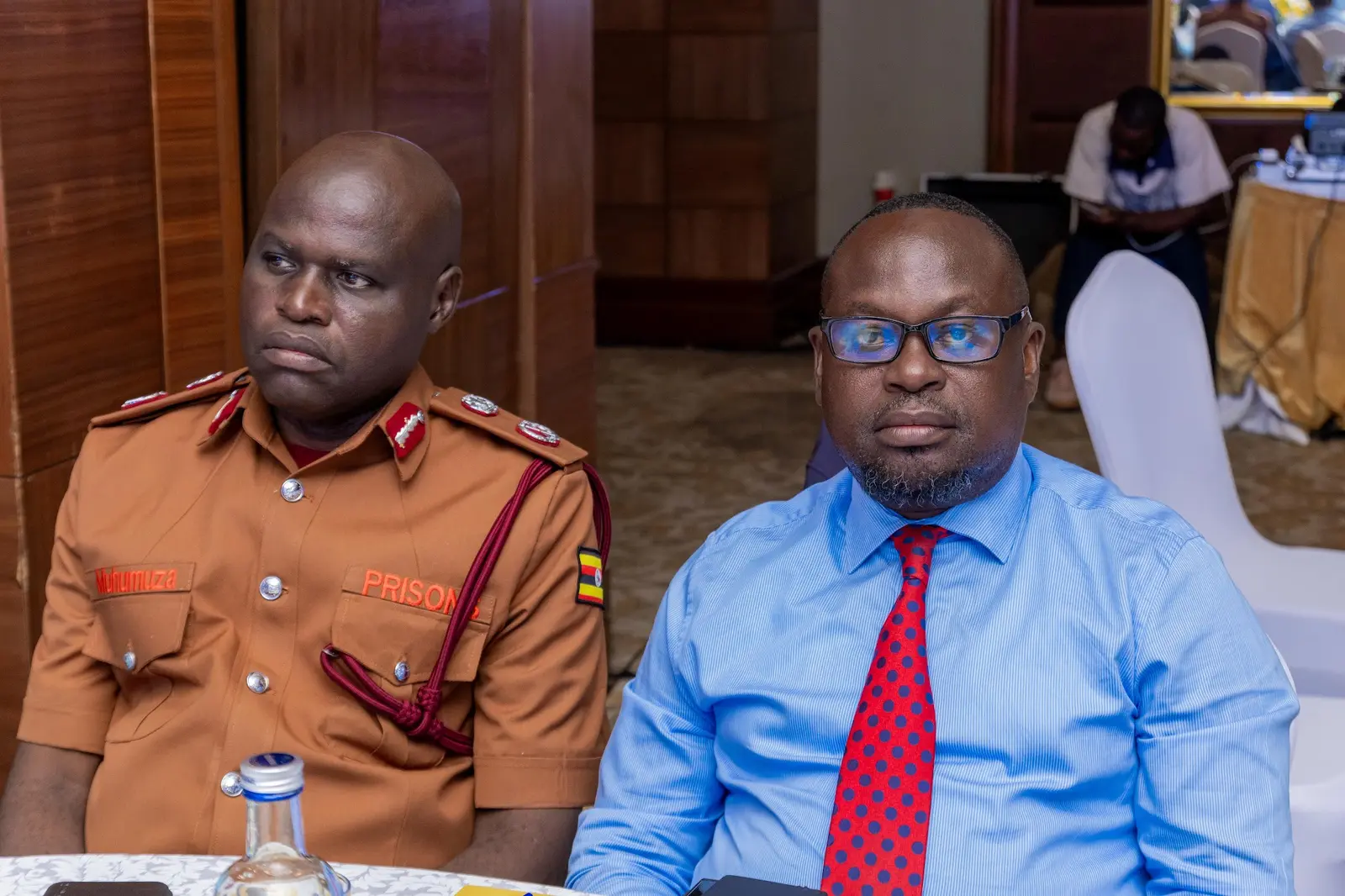 Two delegates listening to a presentation