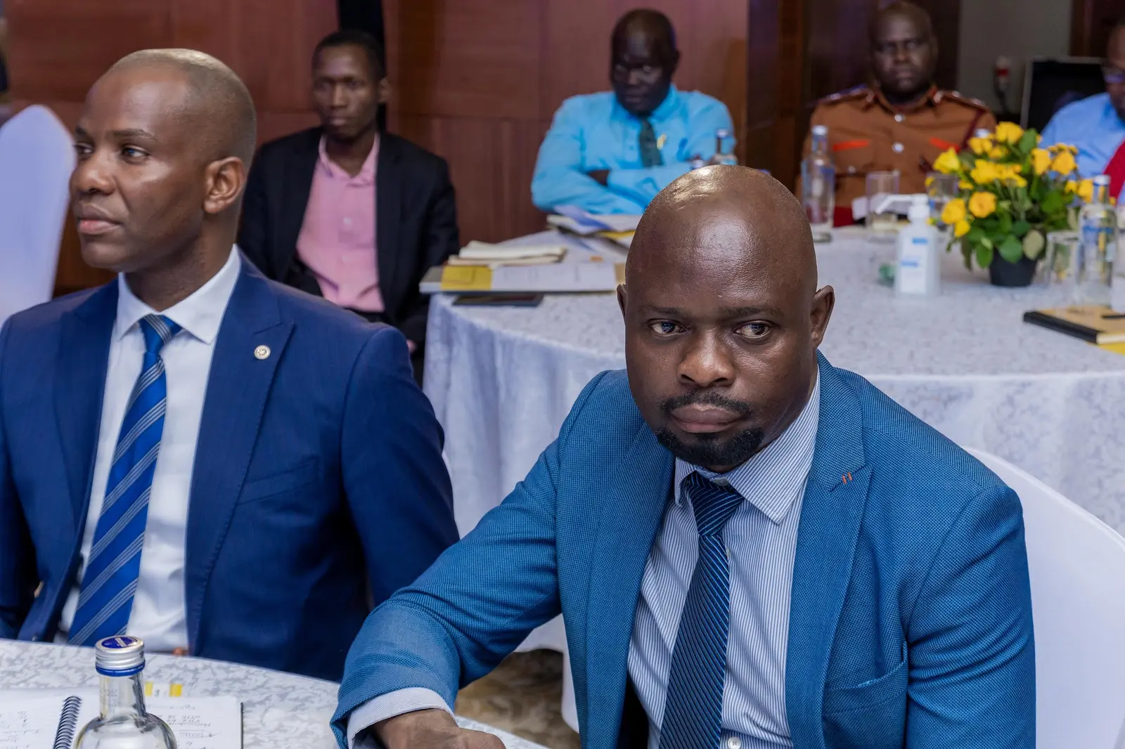 Delegates in suits listening attentively