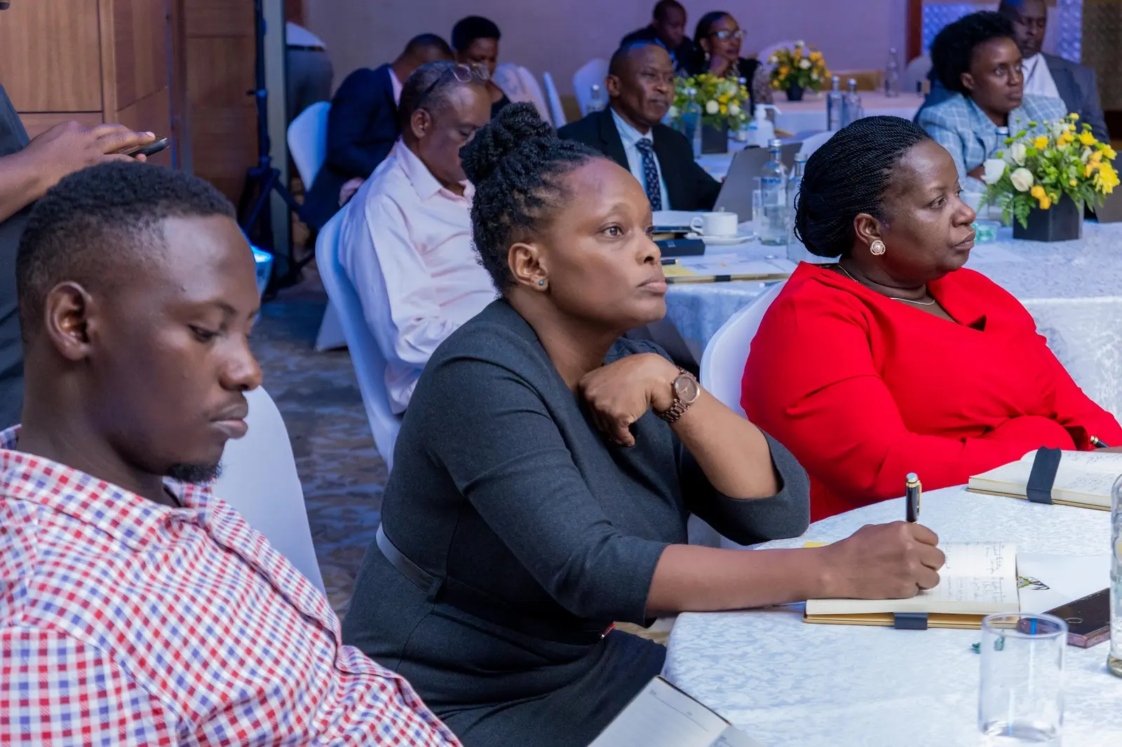 Delegates taking notes at their table