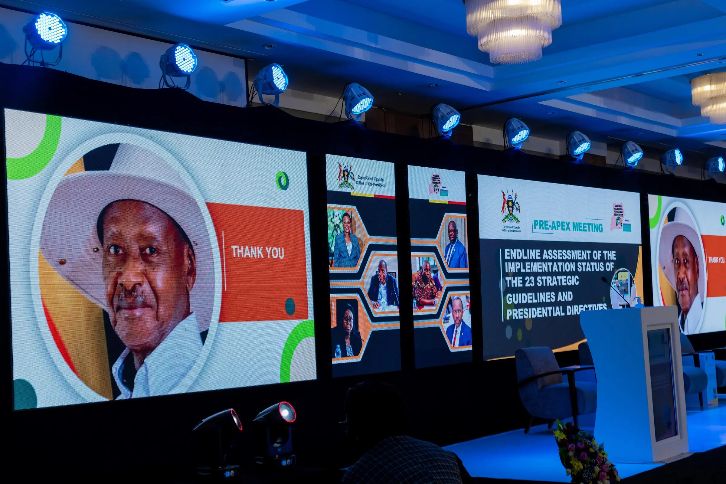 Wall of LED screens showing the meeting branding and a thank-you slide