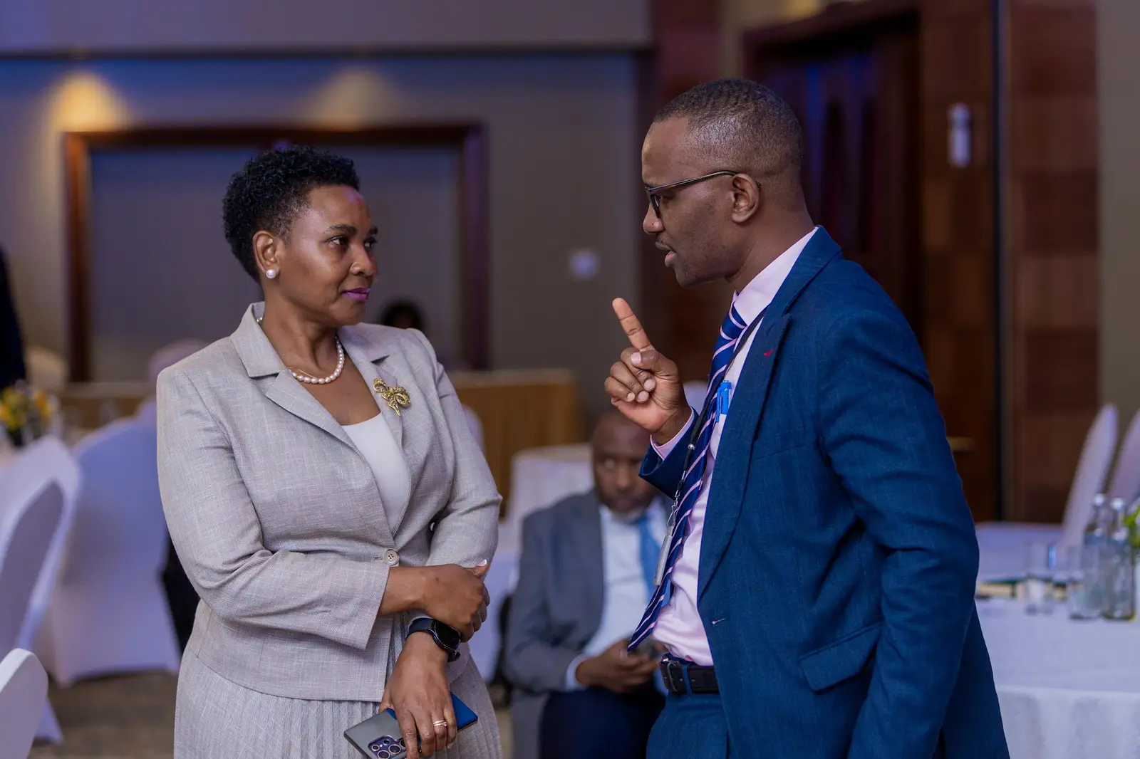 Two delegates in conversation during a break