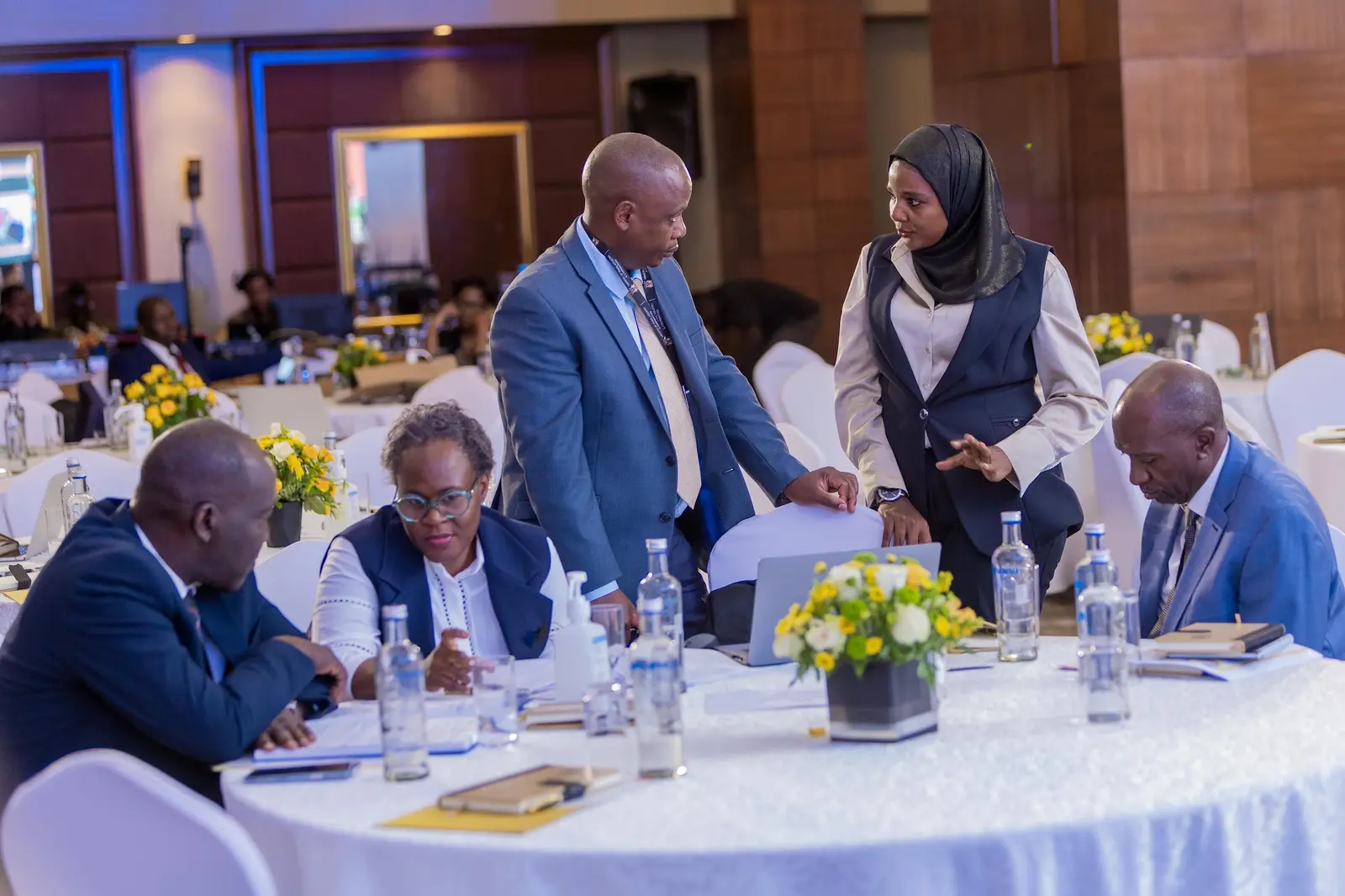 Delegates talking around a table between sessions