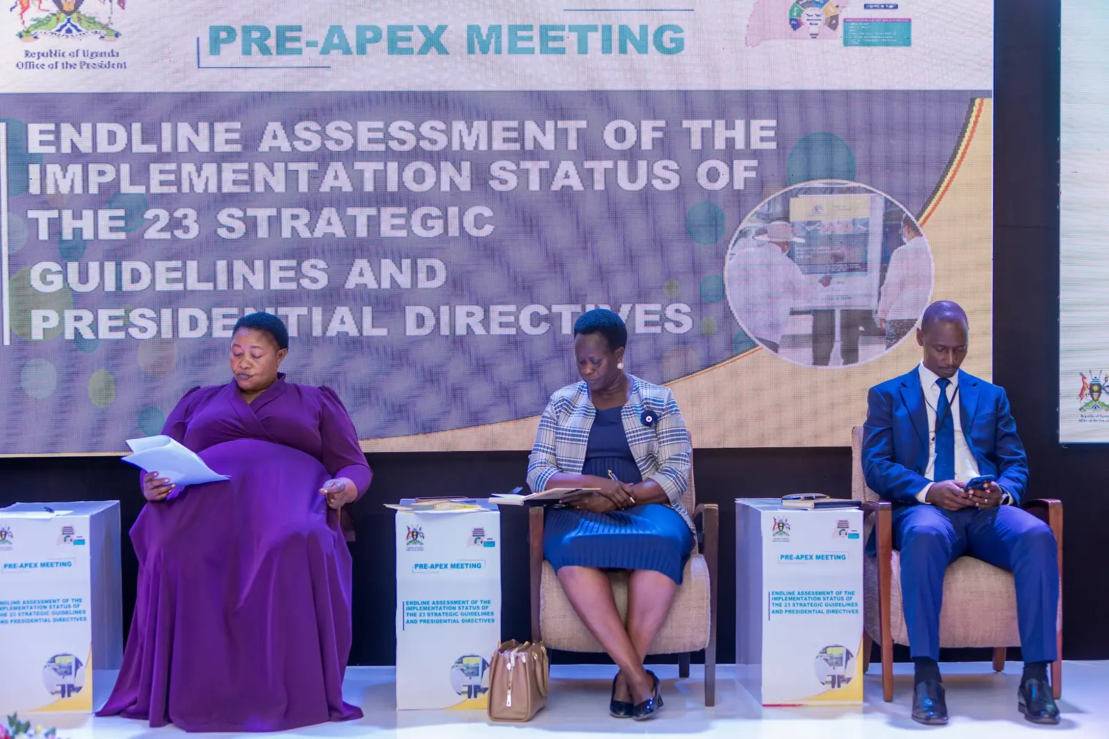 Panellists on stage beneath the endline assessment title screen