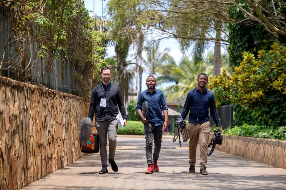 StreamCast crew carrying equipment cases to a venue