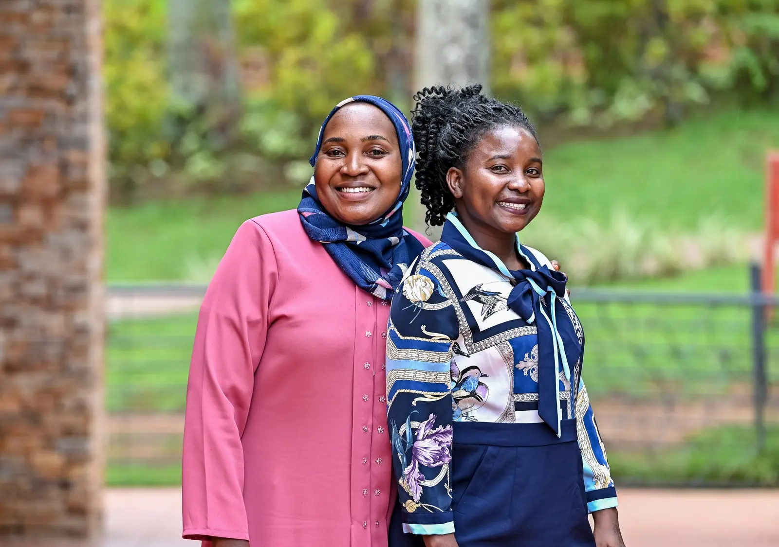 Two guests posing outdoors at the forum venue