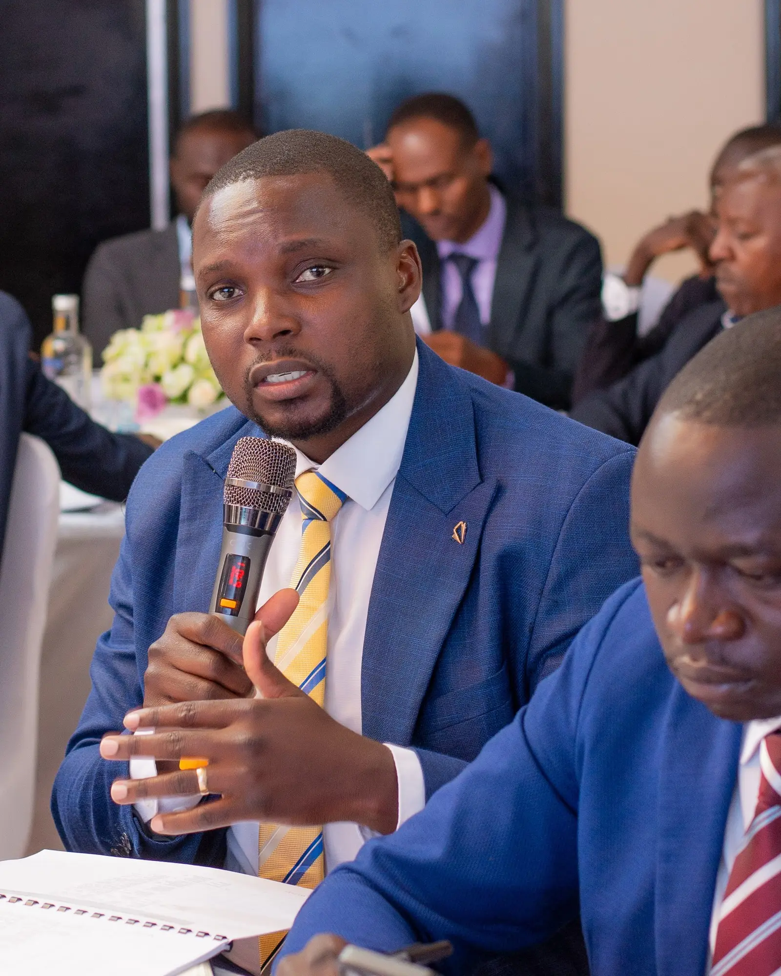 Delegate speaking into a microphone during a forum session