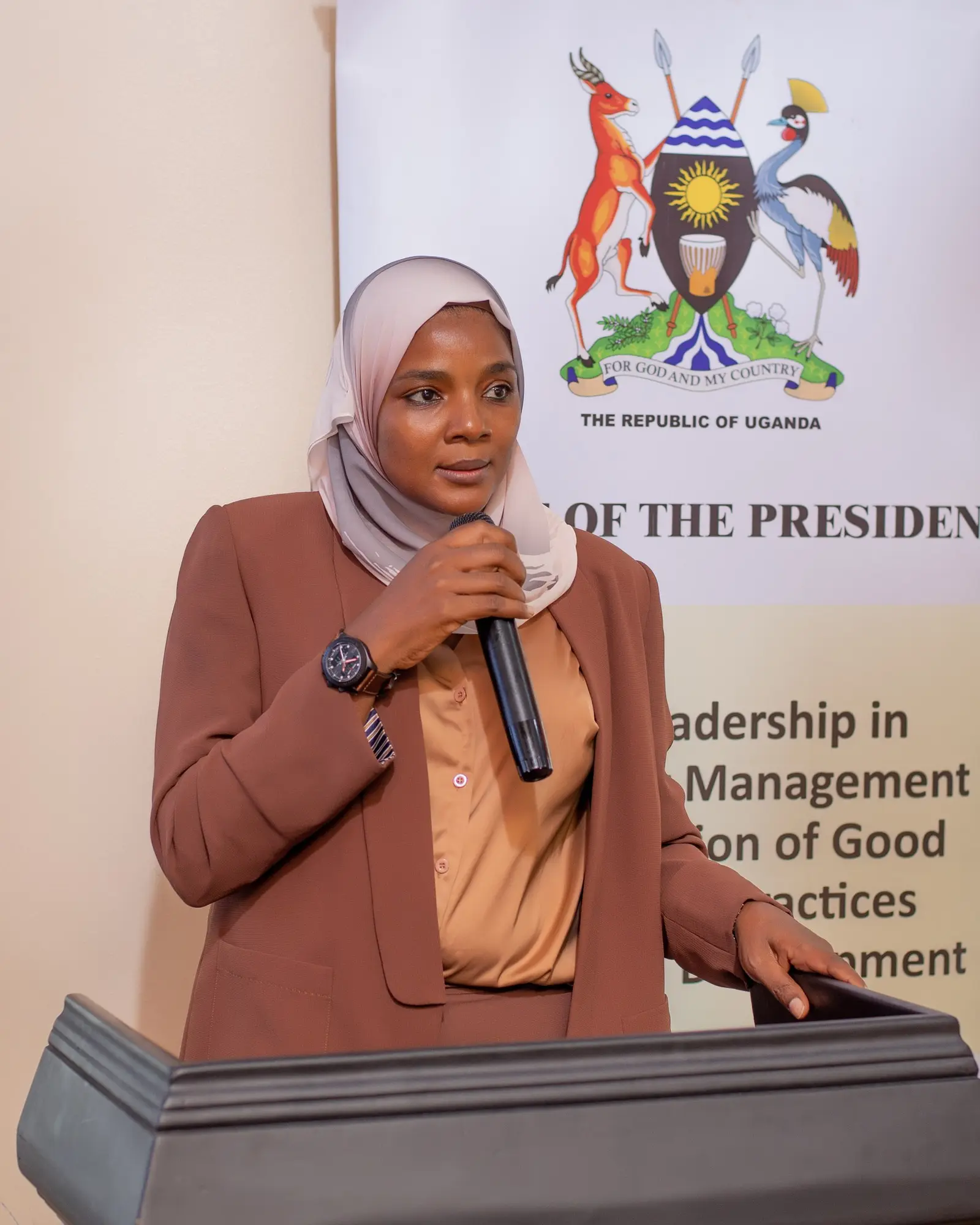 Speaker at the podium in front of an Office of the President banner