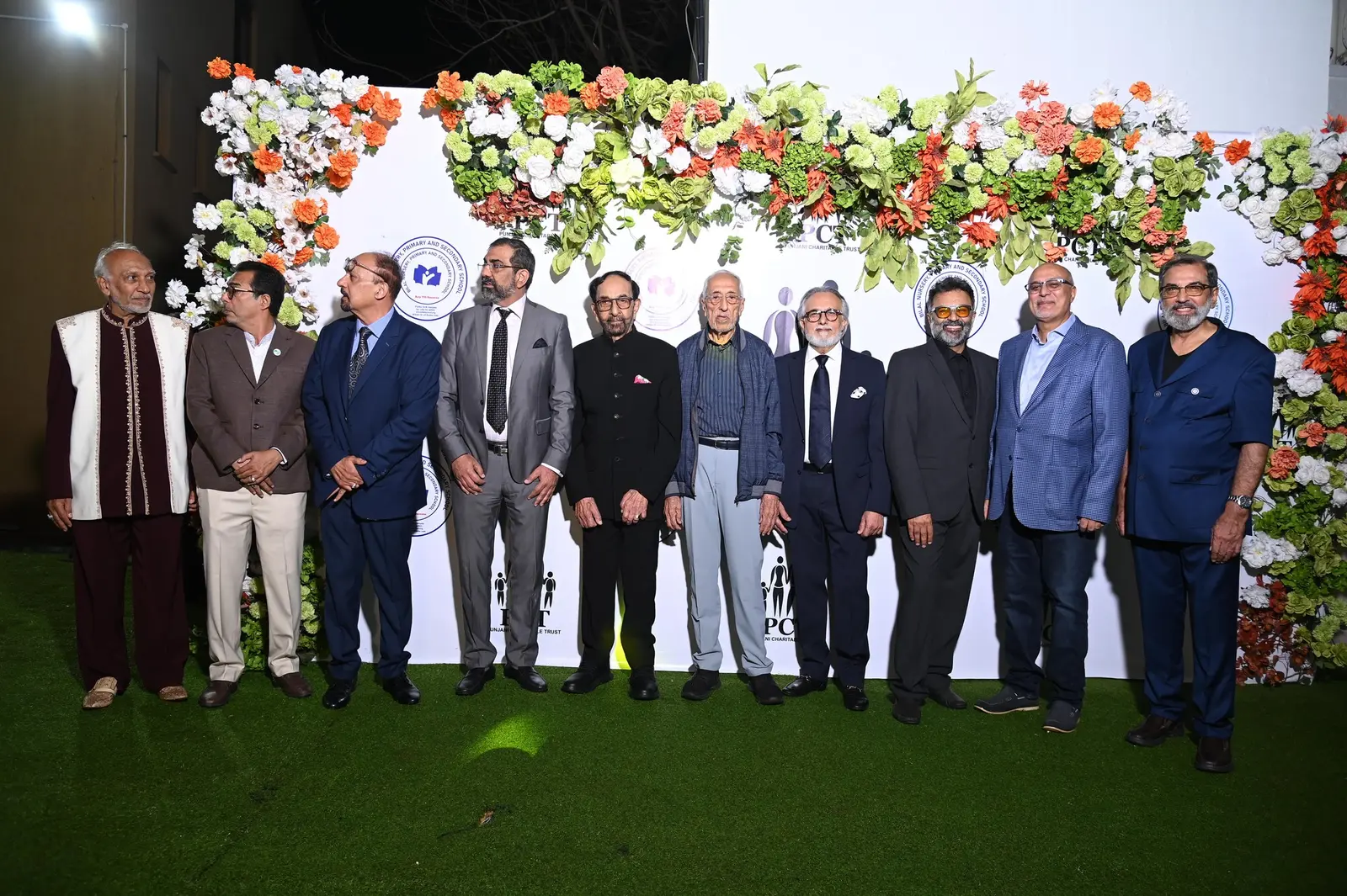 Group photo in front of a floral wall